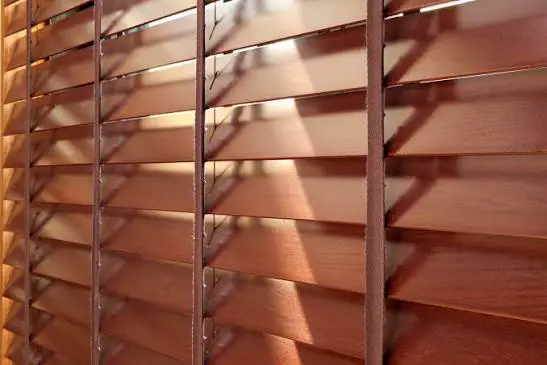 Wooden venetian blinds with adjustable slats